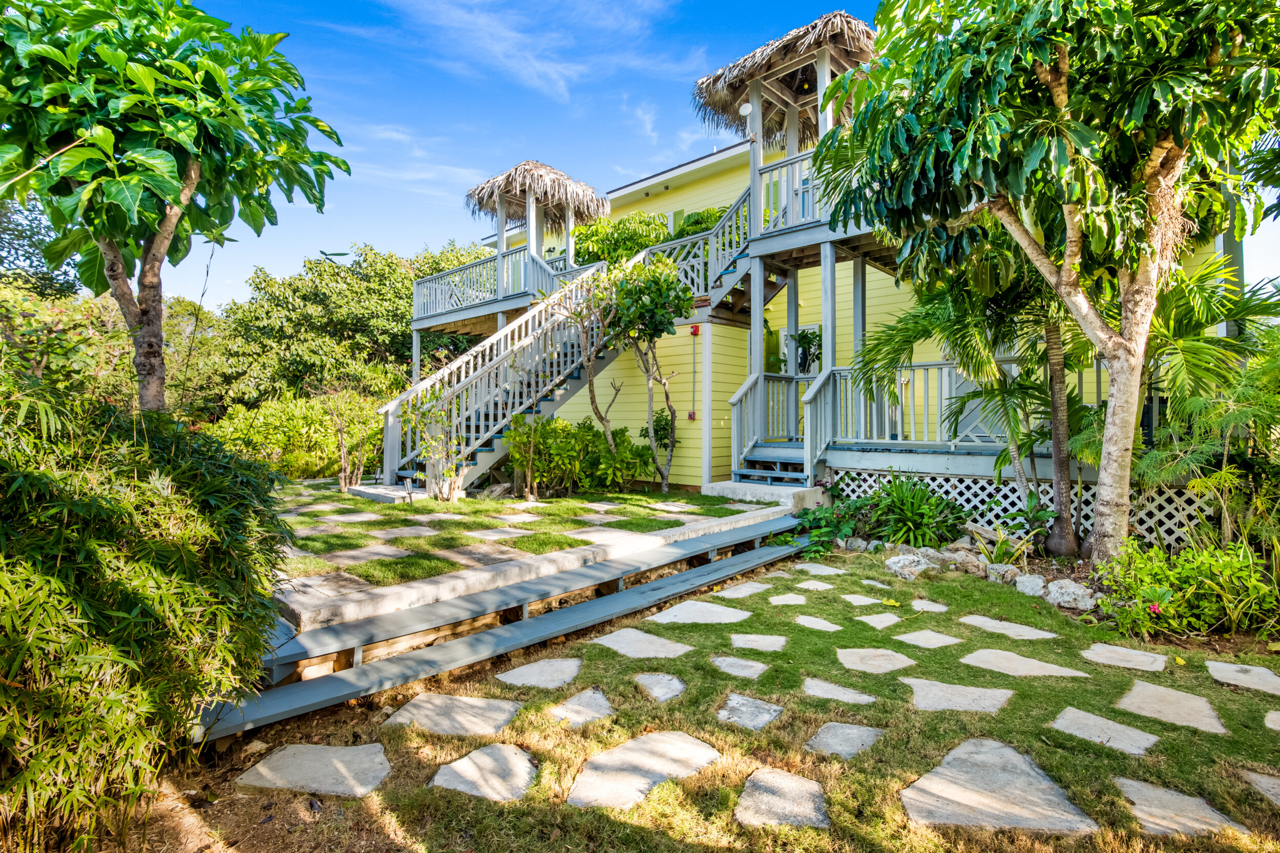 Pineapplefields Resort with wooden staircase surrounded by lush garden