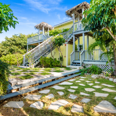 Pineapplefields Resort with wooden staircase surrounded by lush garden